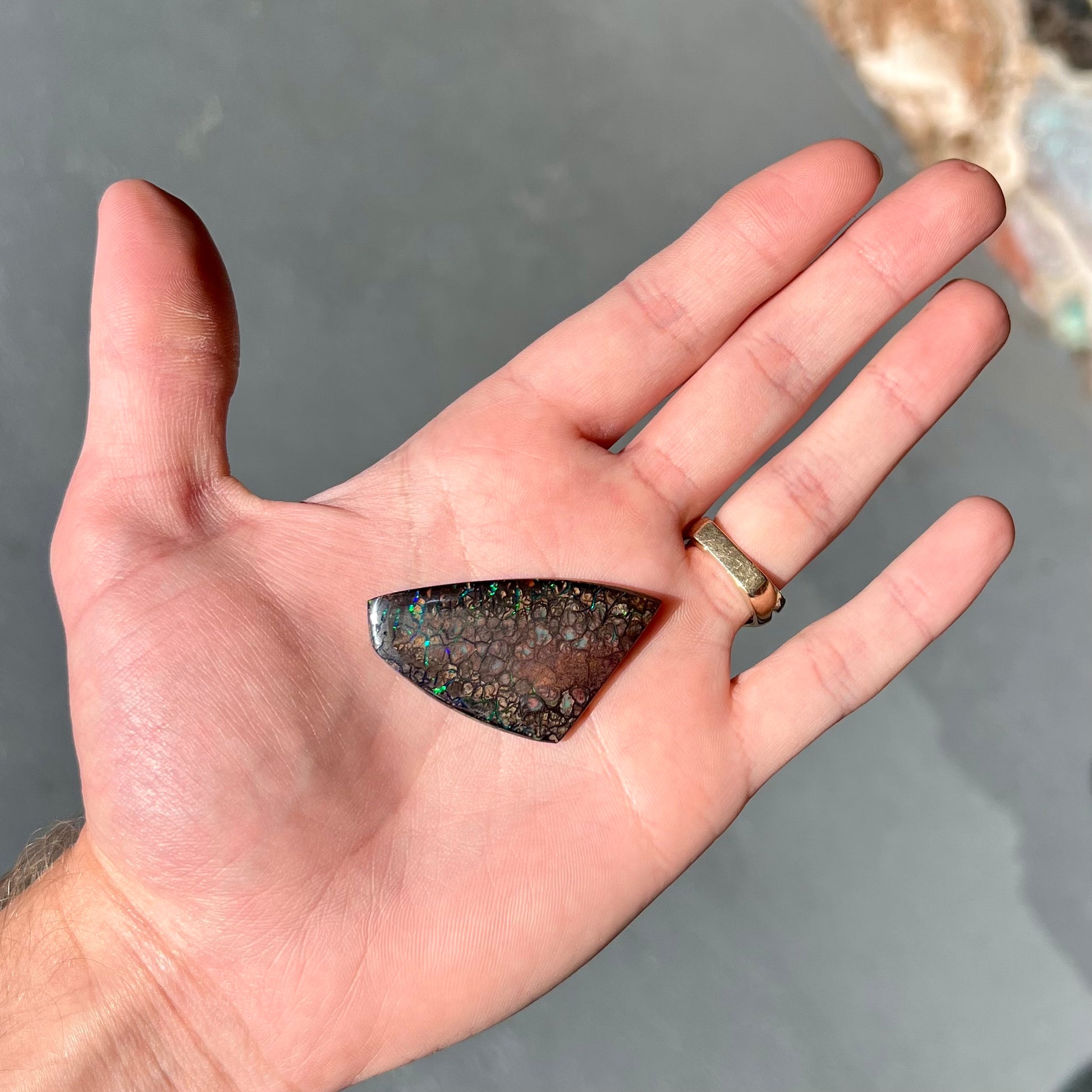 A loose, patterned boulder opal stone from the Koroit Mining District in Queensland, Australia.