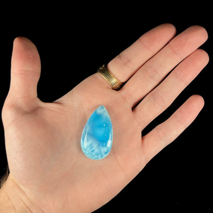 A loose, pear shaped larimar cabochon.  The material is AAA+ grade.