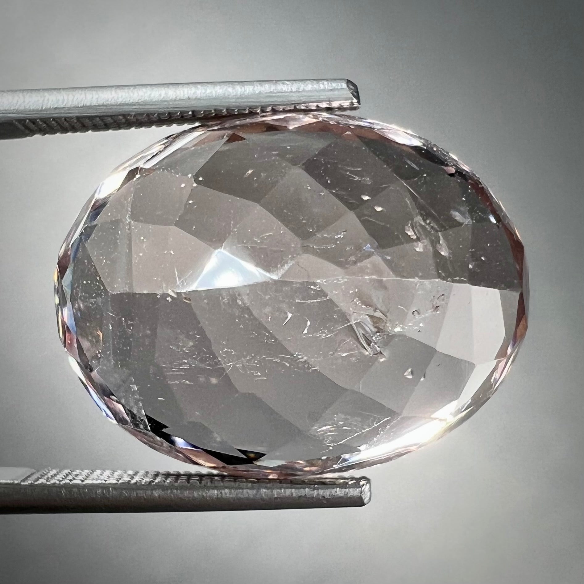 A loose, faceted oval cut pink morganite stone weighing over 14 carats.