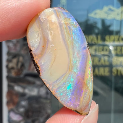A loose, pear shaped cabochon cut boulder opal stone from Quilpie, Australia.