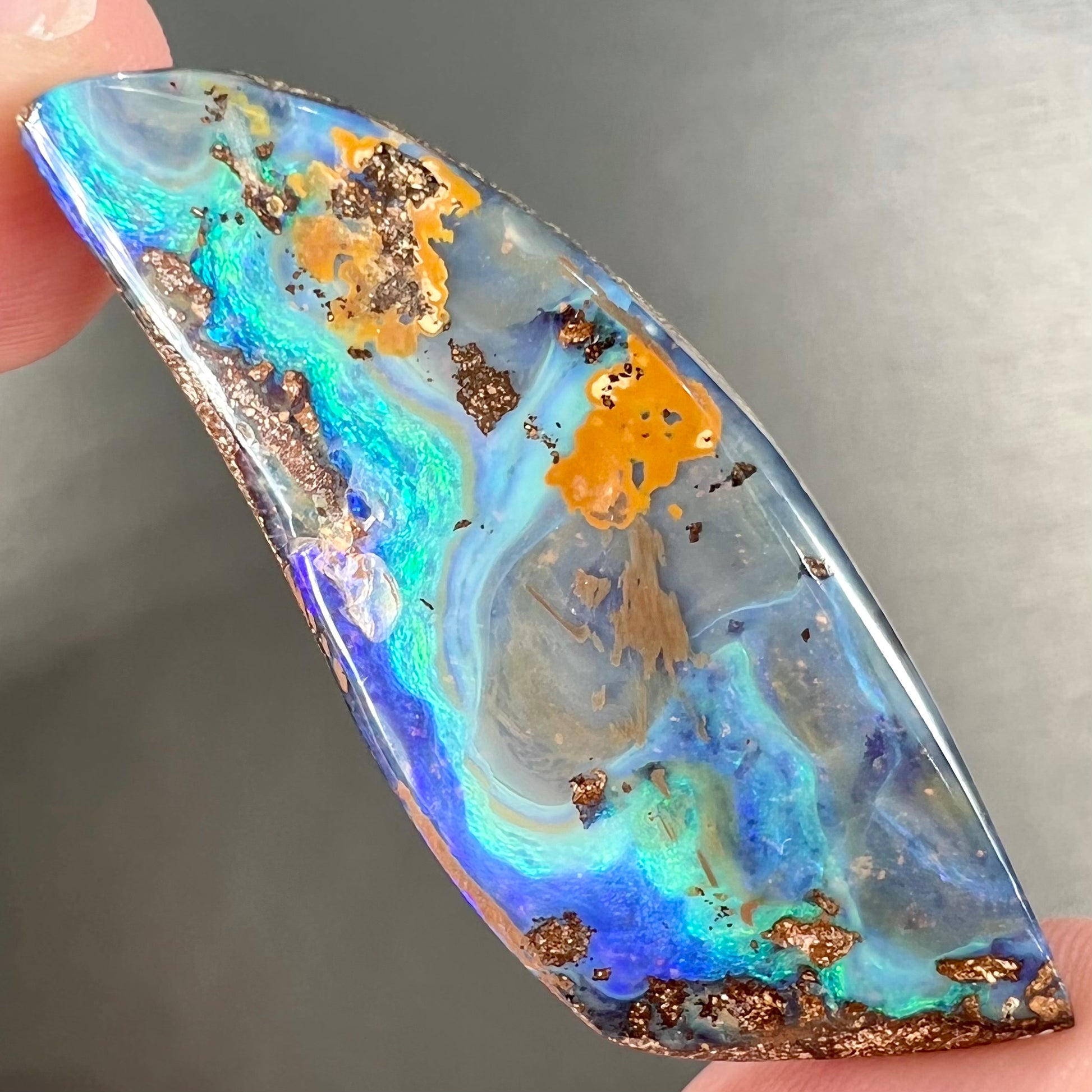 A freeform cut, loose black boulder opal stone from Queensland, Australia.