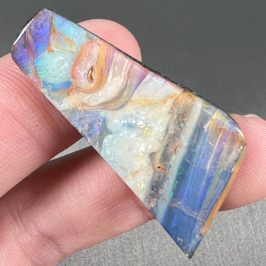 A loose, freeform cut, patterned Quilpie boulder opal stone from Queensland, Australia.