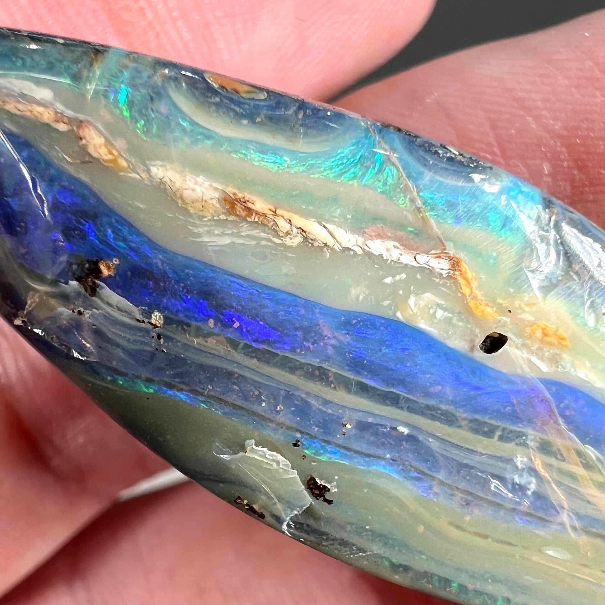A loose, pear shaped boulder opal stone from Queensland, Australia.