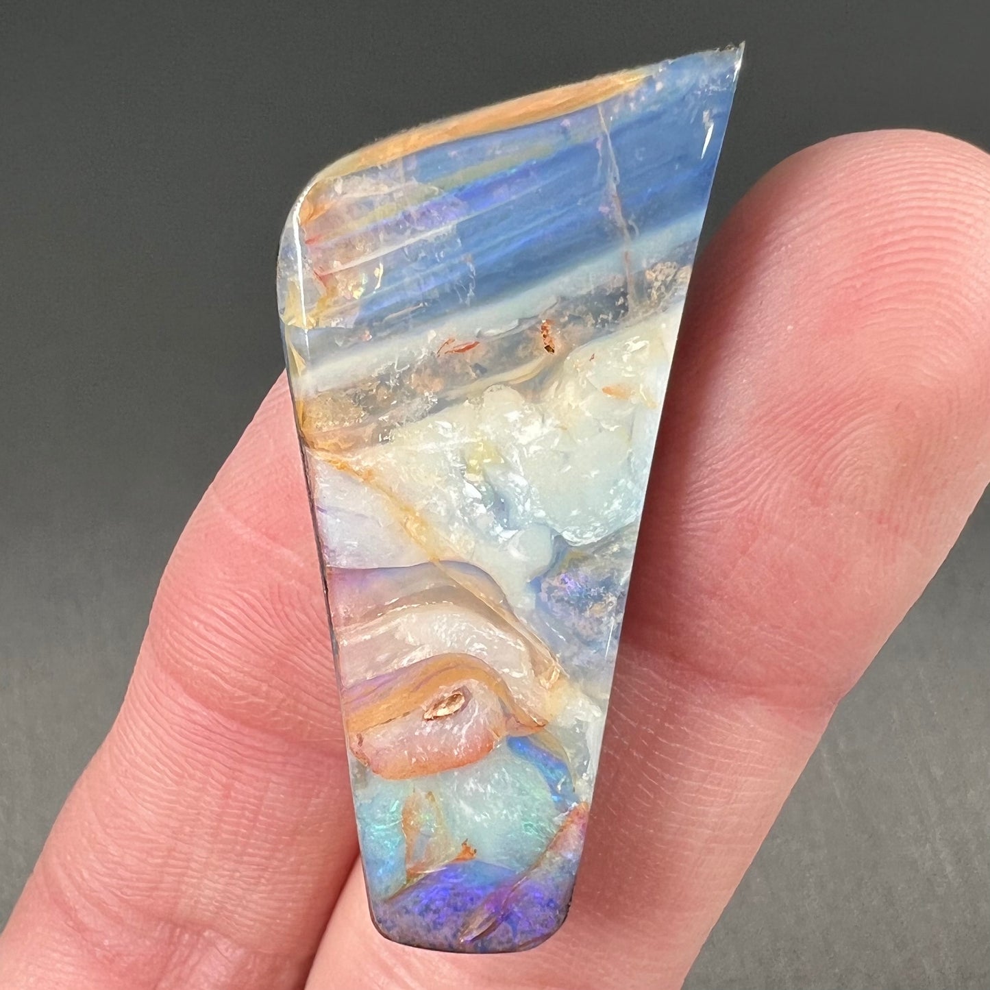 A loose, freeform cut, patterned Quilpie boulder opal stone from Queensland, Australia.