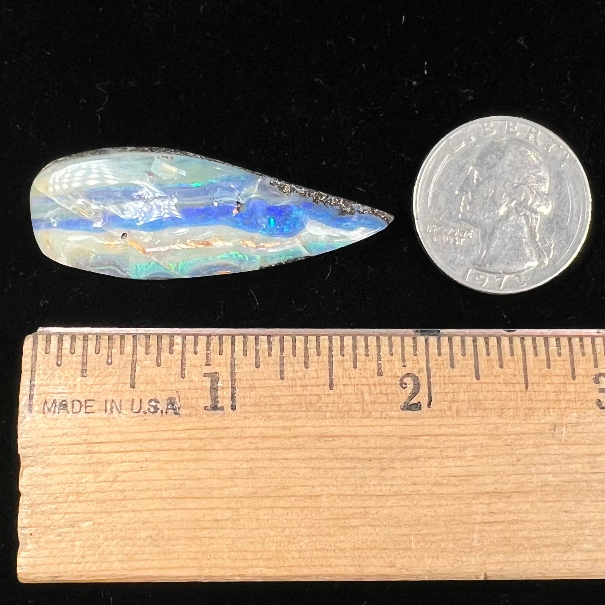A loose, pear shaped boulder opal stone from Queensland, Australia.
