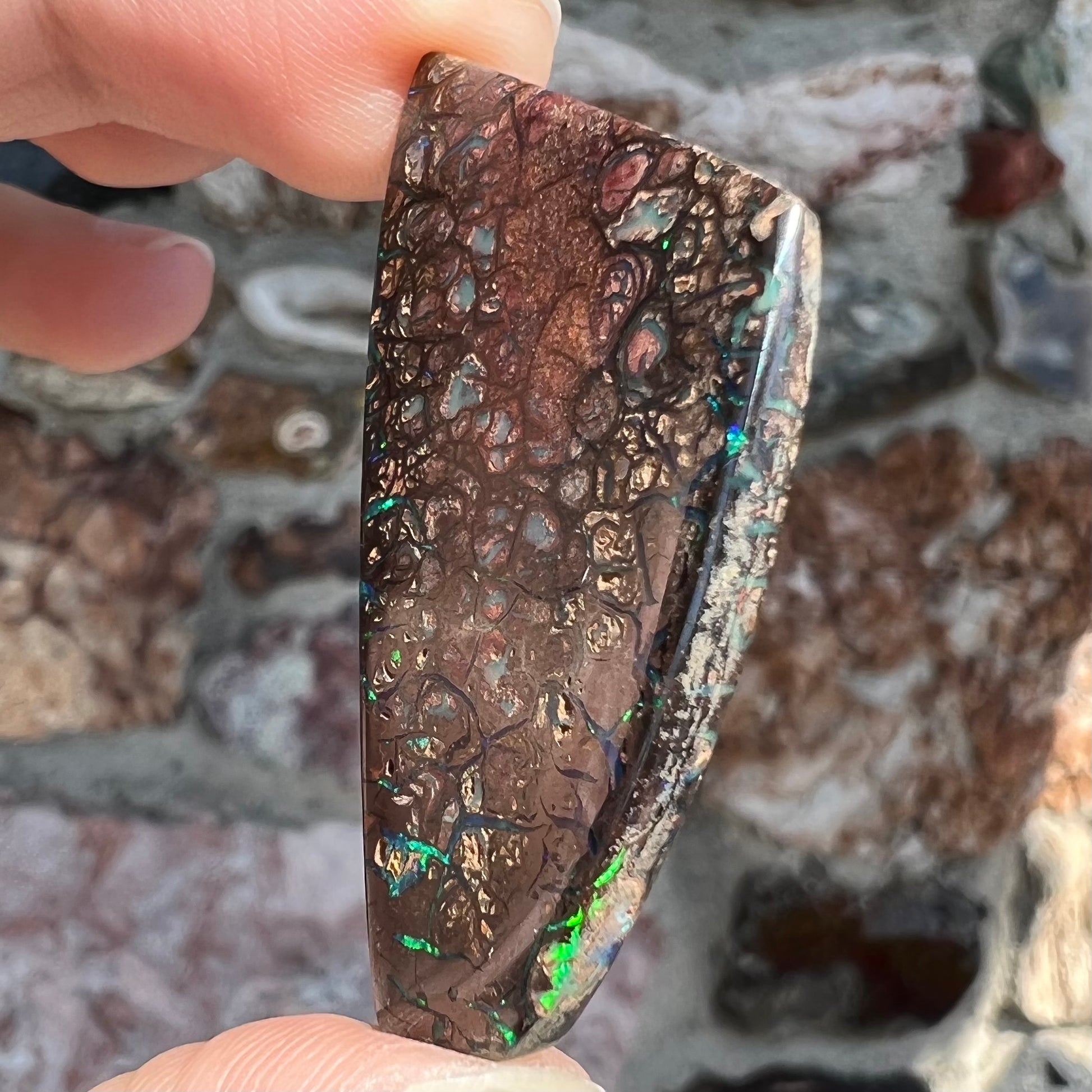 A loose, patterned boulder opal stone from the Koroit Mining District in Queensland, Australia.