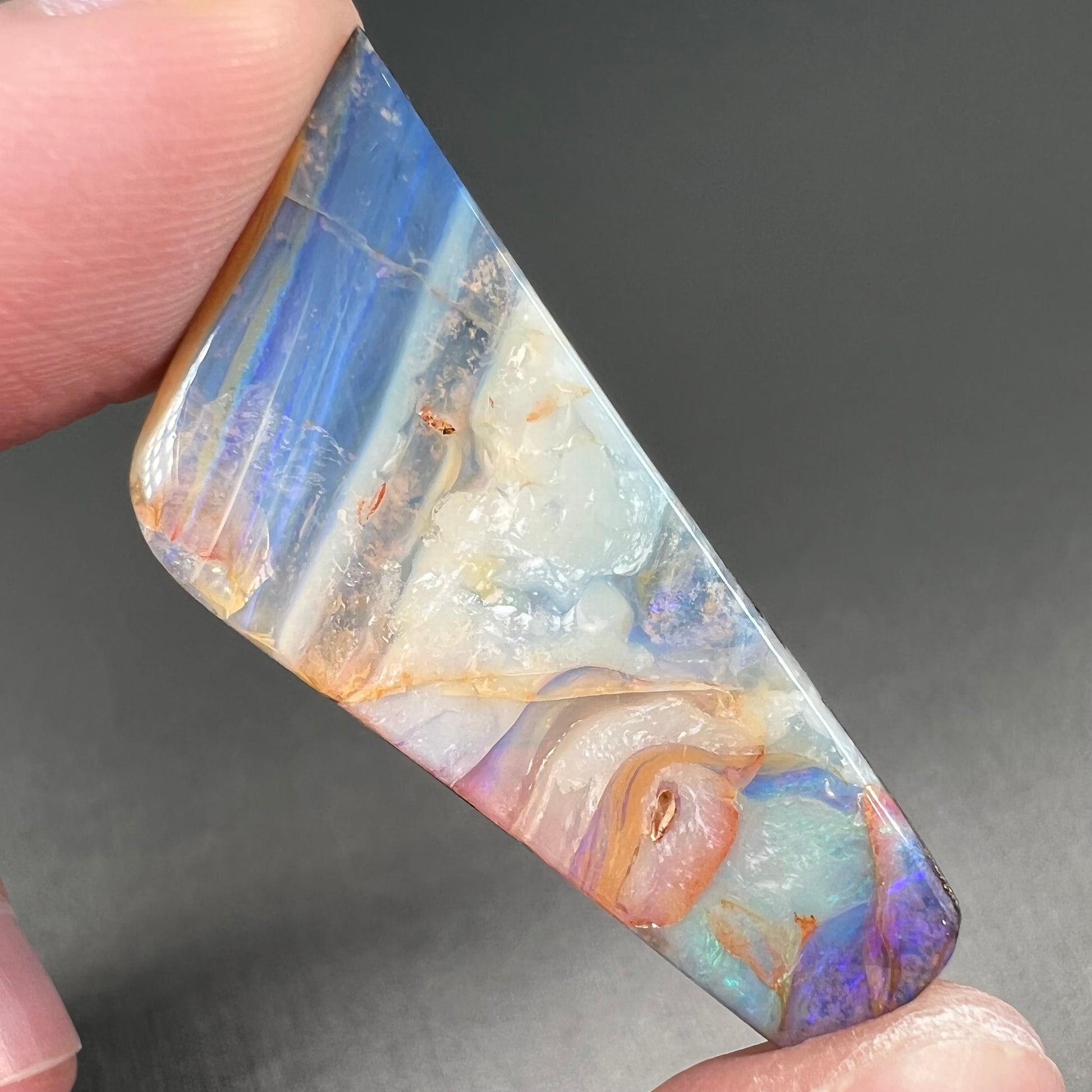A loose, freeform cut, patterned Quilpie boulder opal stone from Queensland, Australia.