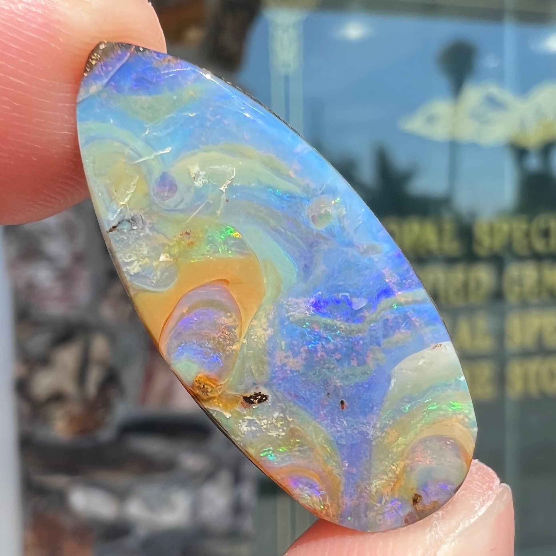 A loose, natural, pear shaped boulder opal stone from Quilpie, Australia.