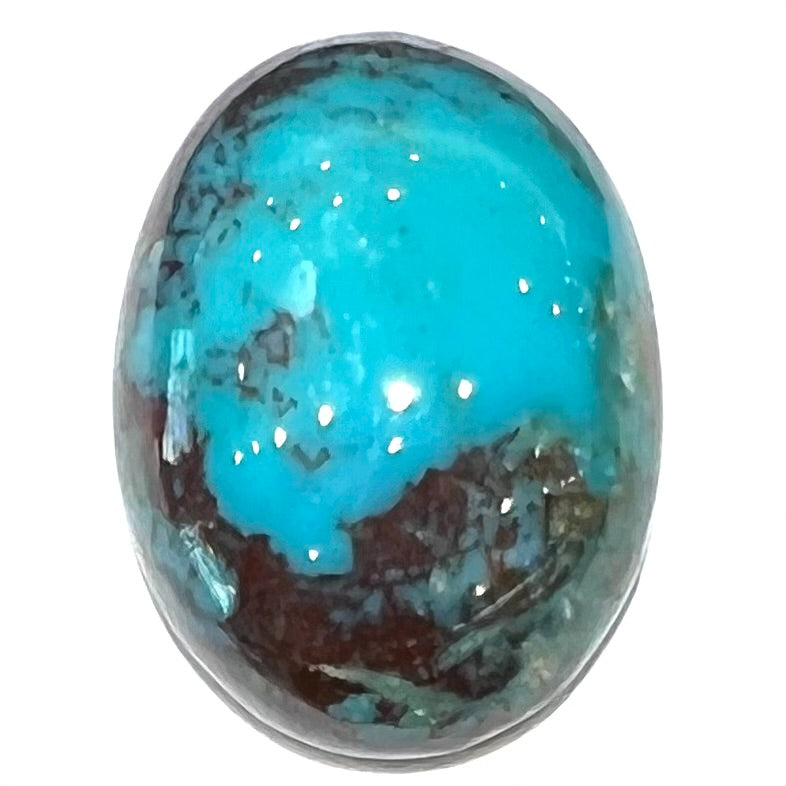 An oval cabochon cut blue turquoise stone with red cuprite inclusions from Royston District, Nevada.