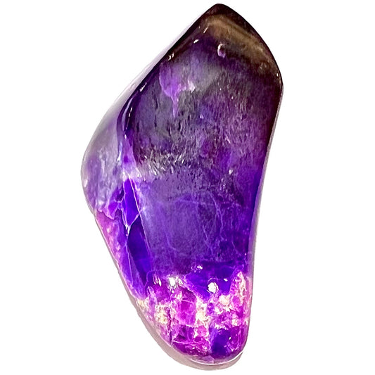 A loose, polished sugilite specimen displaying a blend of different shades of purple.