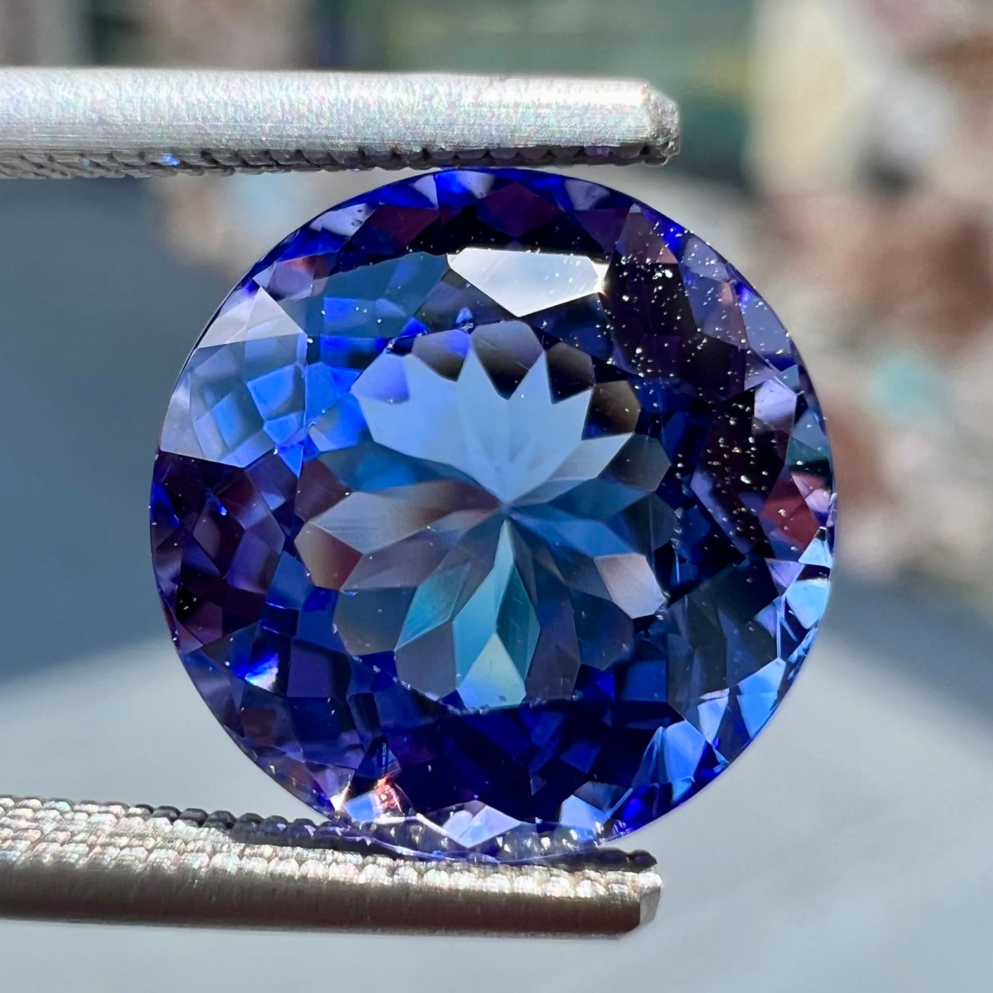 A loose, AA grade Standard Round Brilliant Cut tanzanite stone.