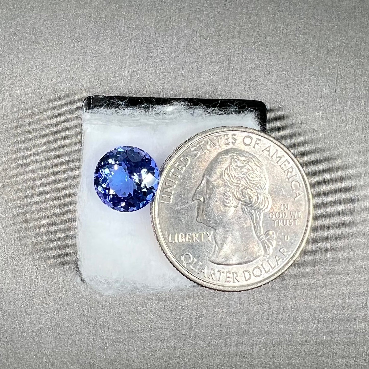 A loose, AA grade Standard Round Brilliant Cut tanzanite stone.