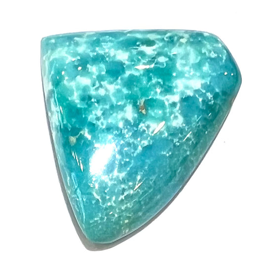 One loose triangular cut cabochon turquoise stone from Sonora, Mexico.