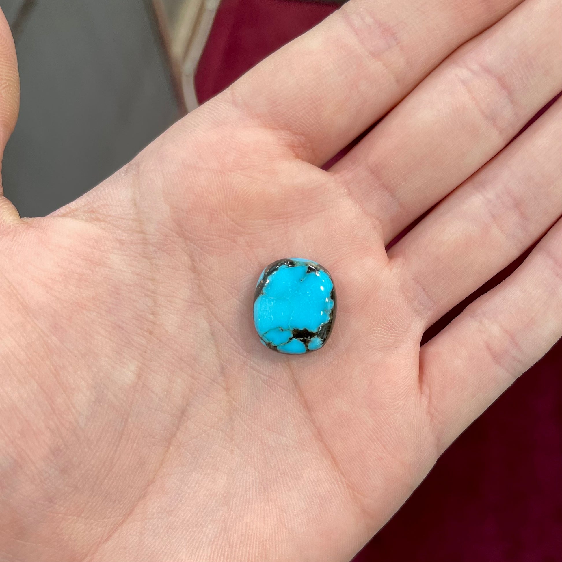 A loose turquoise stone from Pinto Valley Mine, Arizona.  The piece is blue with a black matrix.