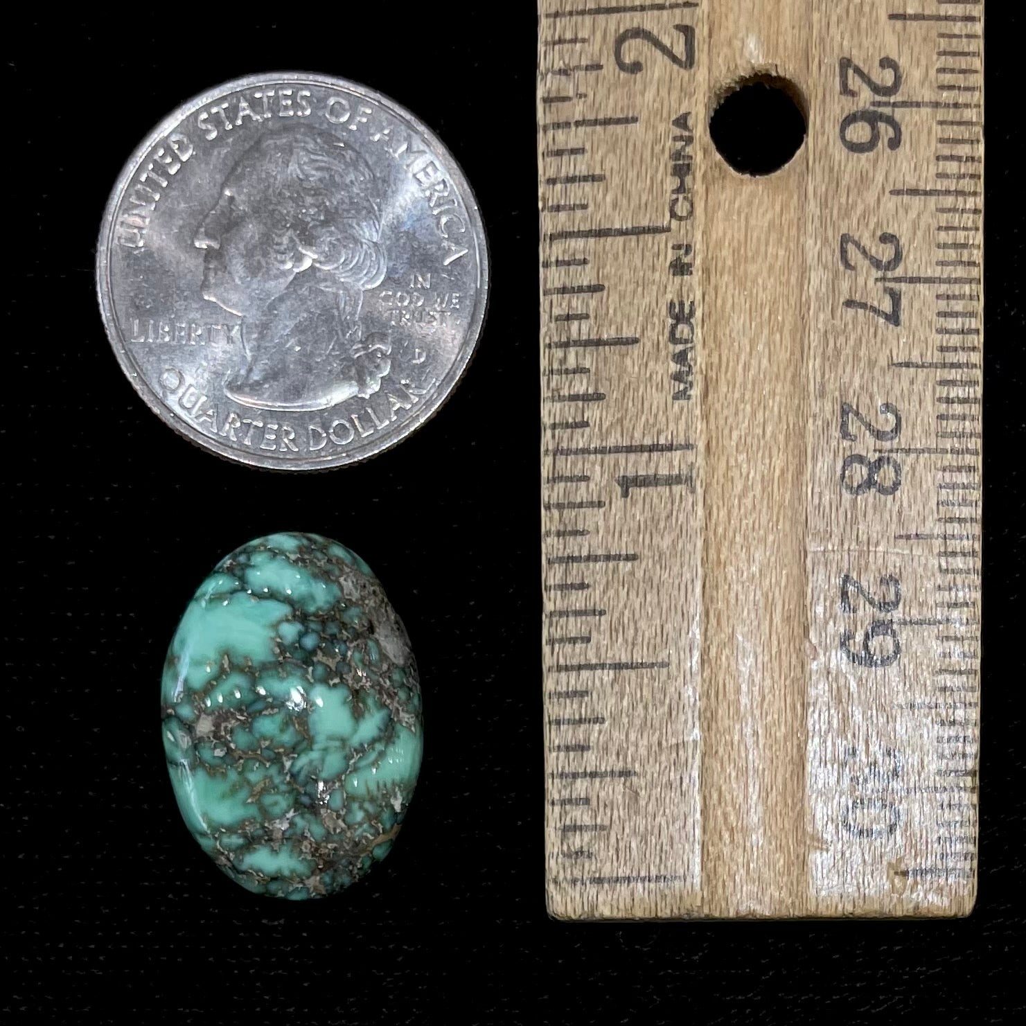 A loose, oval cabochon cut variscite stone from Utah, USA.
