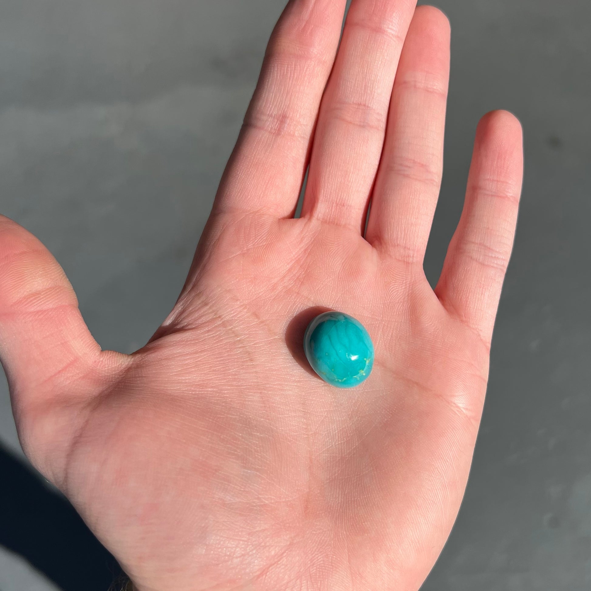 An oval cabochon cut blue turquoise stone from Royston District, Nevada.