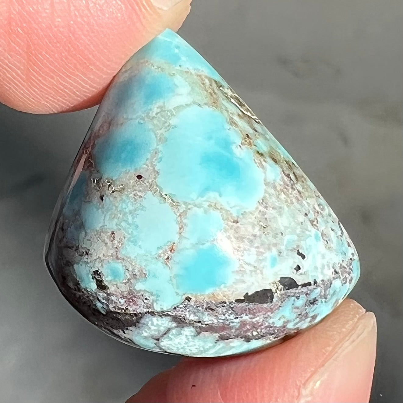 A loose triangular cabochon cut turquoise from the Valley Blue Mine in Lander County, Nevada.