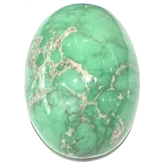 A loose, oval cabochon cut green variscite stone from Utah, USA.