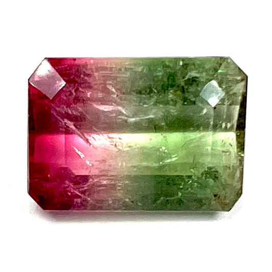 A loose pink and green emerald cut watermelon tourmaline gemstone.