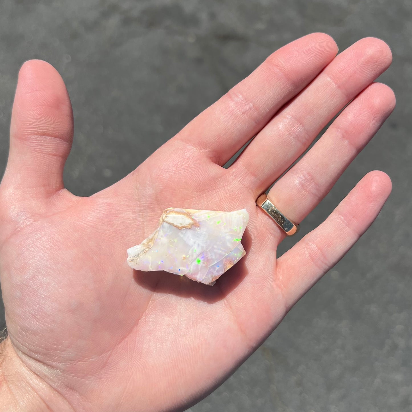 A loose, polished specimen of white crystal opal from Spencer, Idaho, USA.