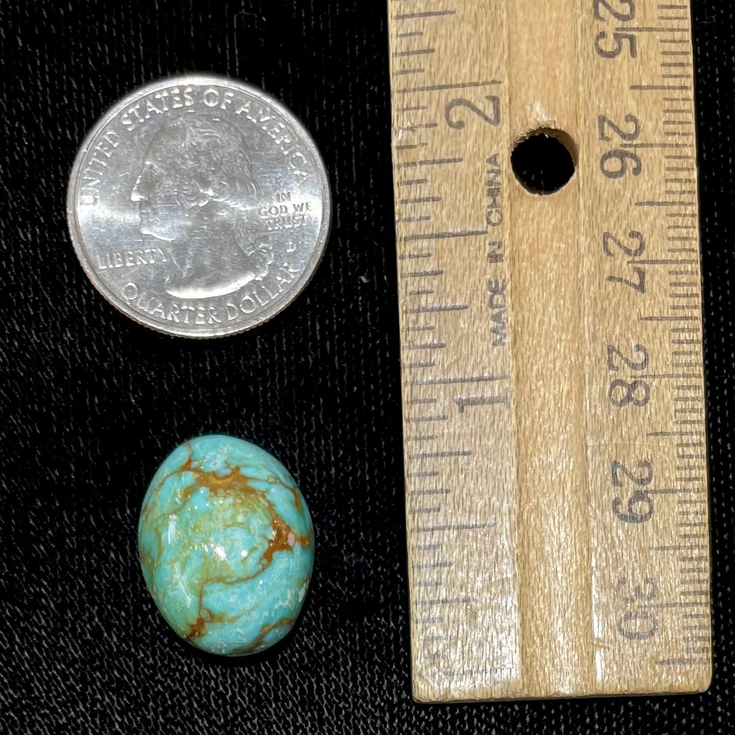 A loose, greenish blue turquoise stone with brown matrix from the Royston Mining District in Nevada.