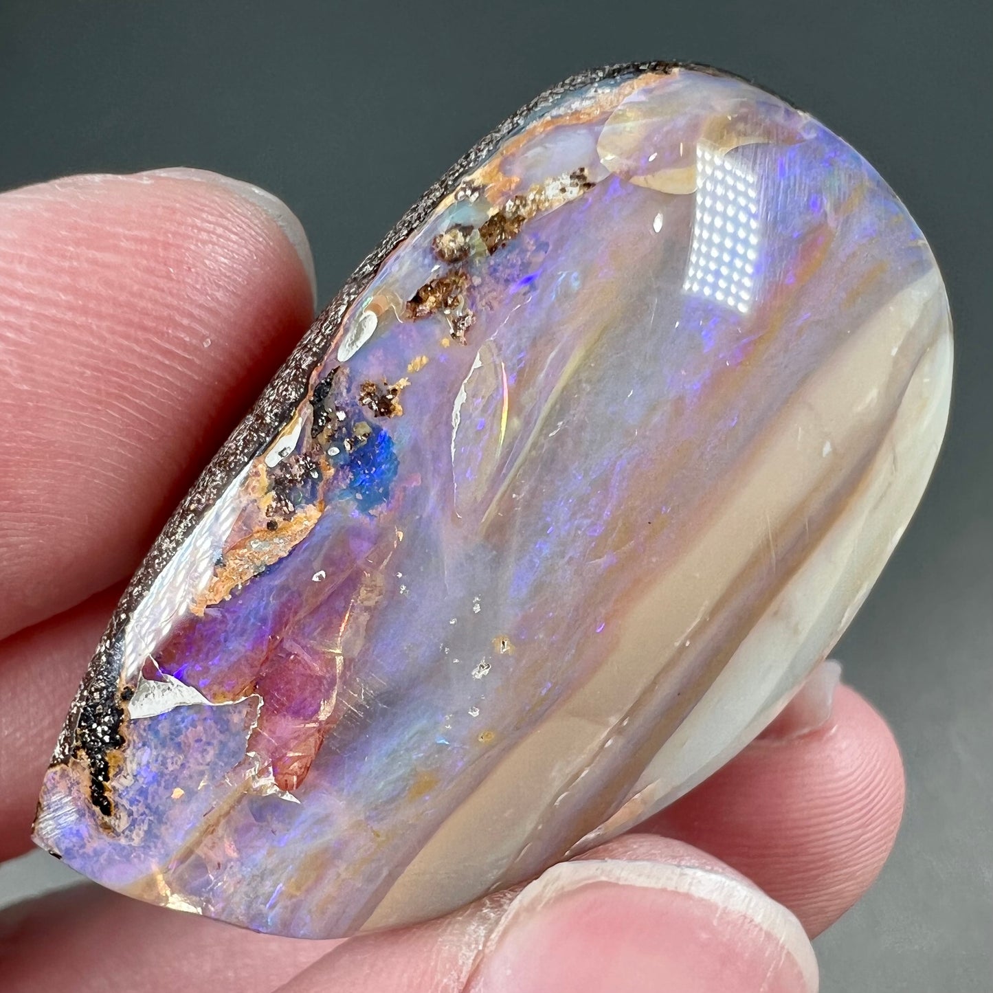 A loose, drop shaped Australian boulder opal from Quilpie Mining District.
