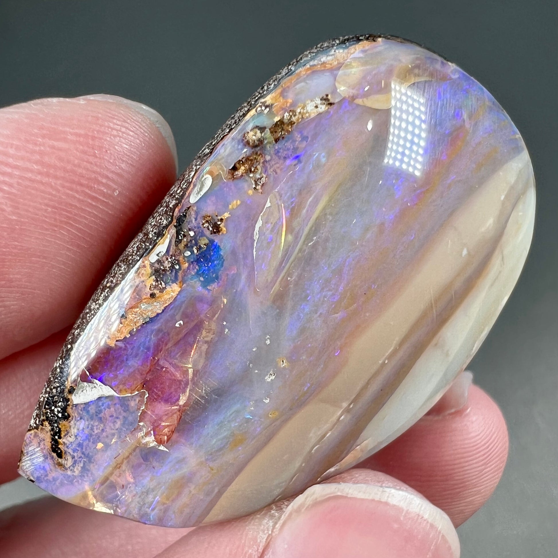 A loose, drop shaped Australian boulder opal from Quilpie Mining District.