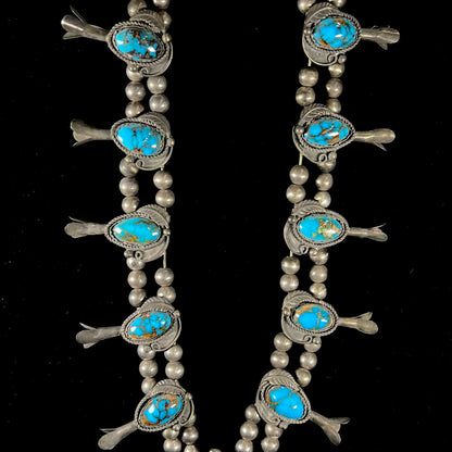 A silver Navajo men's squash blossom necklace set with Fox turquoise and Sonora turquoise.