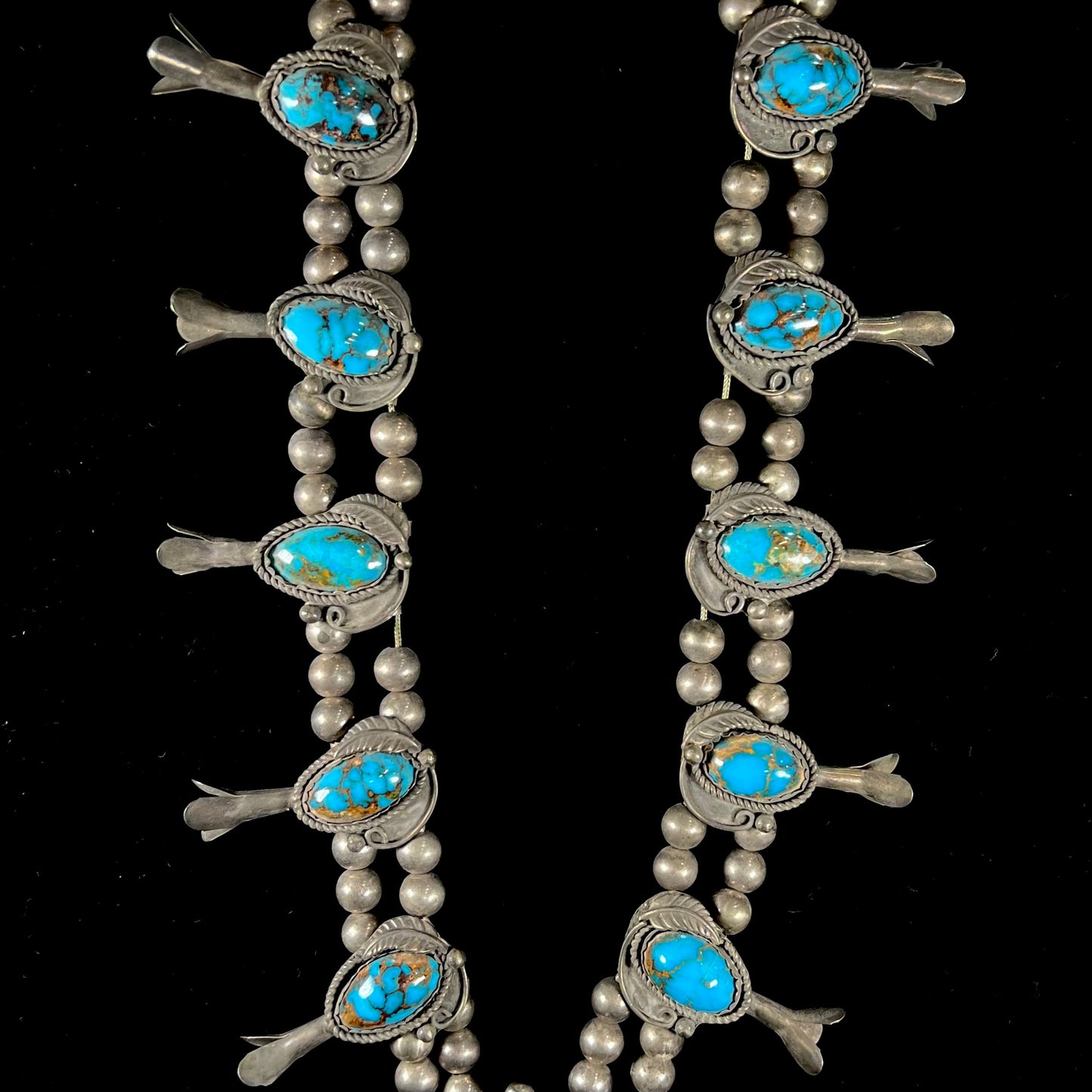 A silver Navajo men's squash blossom necklace set with Fox turquoise and Sonora turquoise.