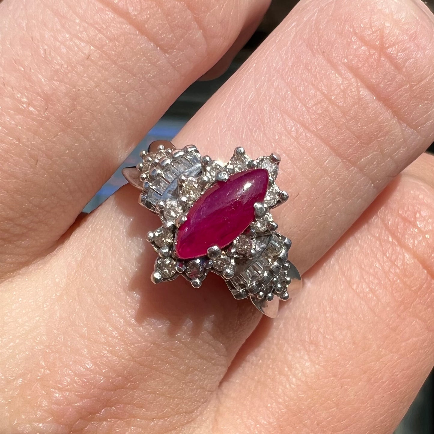 A vintage style white gold marquise cabochon cut ruby and diamond ring.