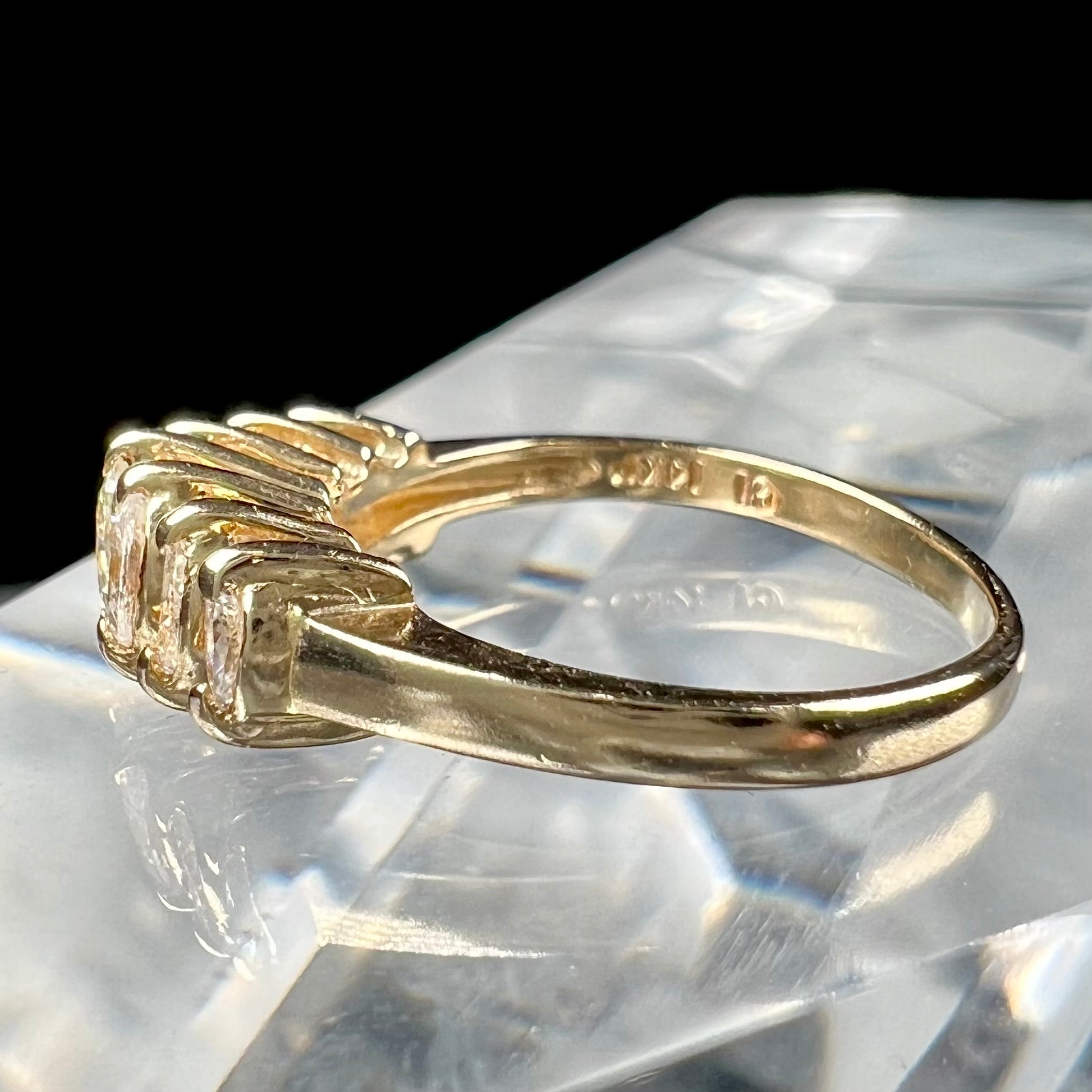 An estate yellow gold ring prong set with seven marquise cut diamonds.