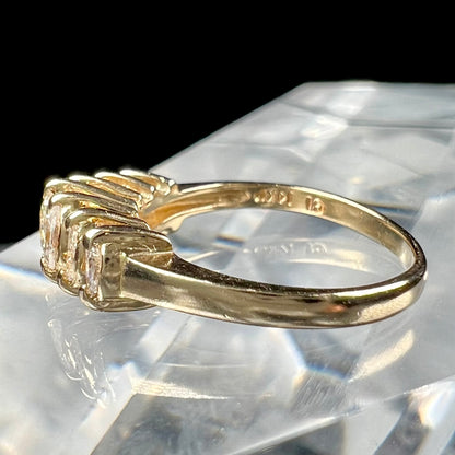 An estate yellow gold ring prong set with seven marquise cut diamonds.