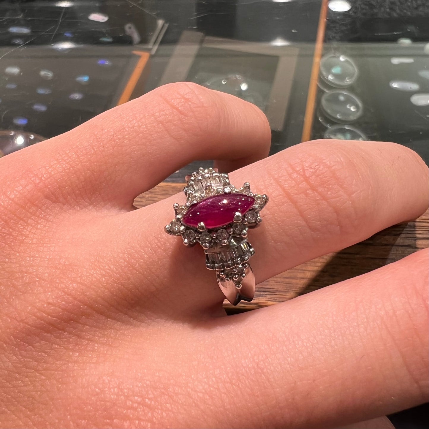 A vintage style white gold marquise cabochon cut ruby and diamond ring.