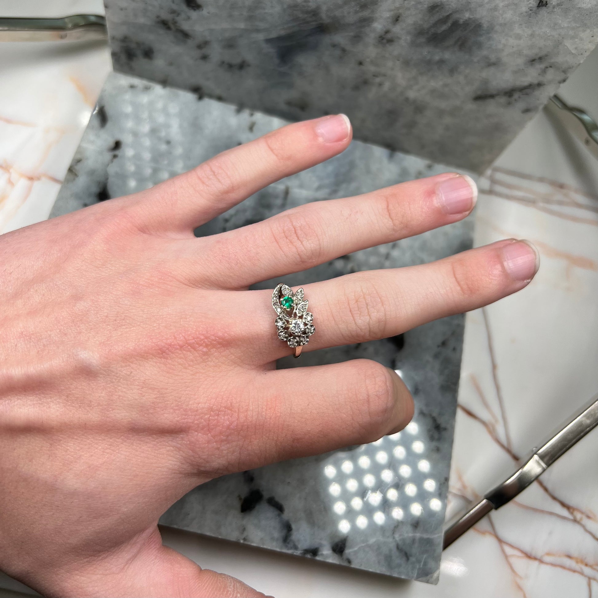 Vintage gold round cut emerald and diamond ring.