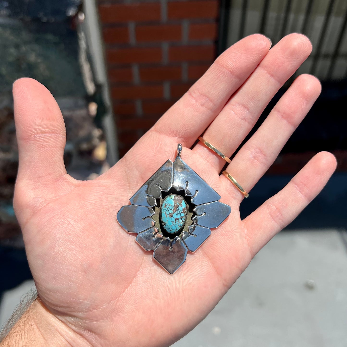 A handmade Mayan Indian pendant set with an oval cut turquoise stone from the Number 8 Mine.