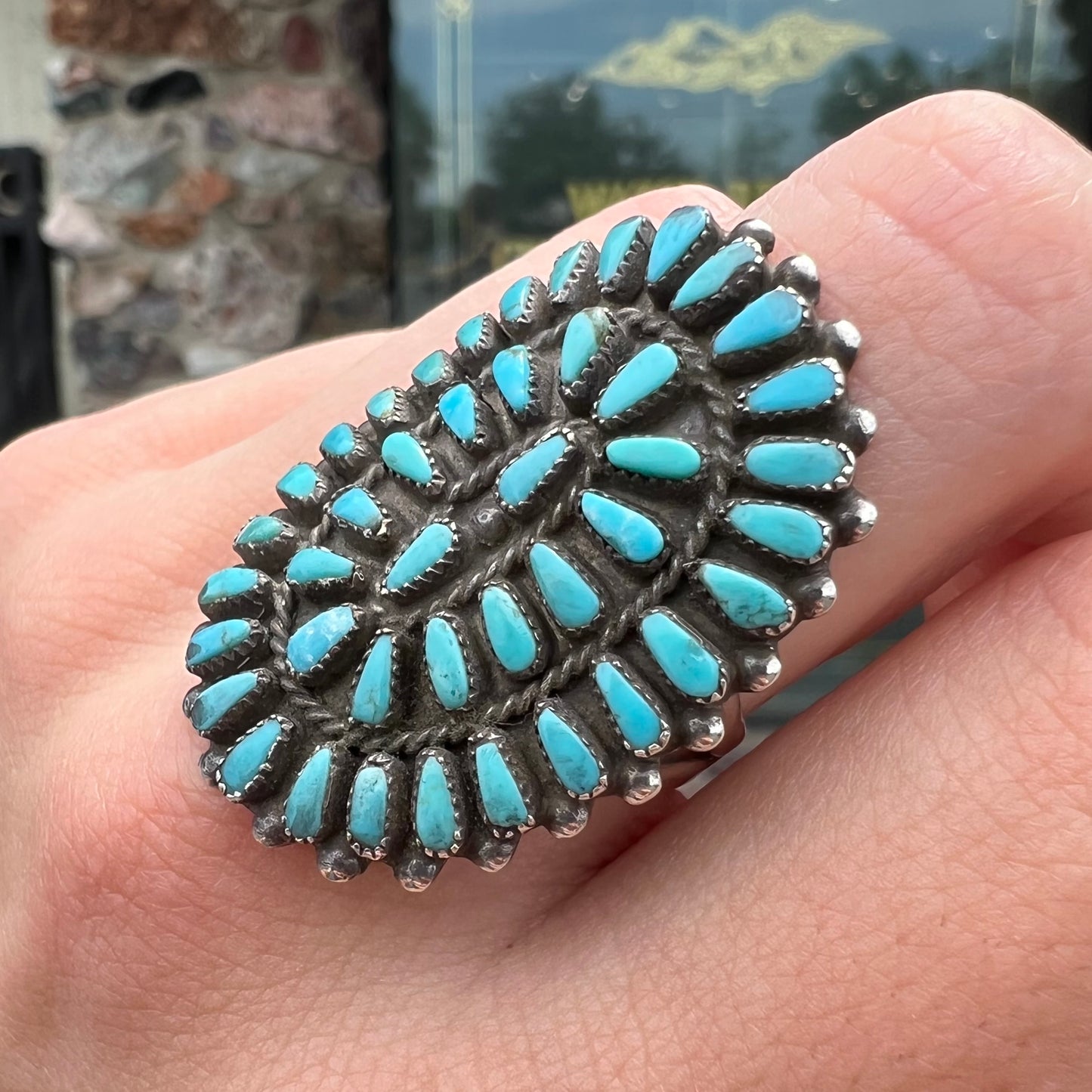 A petit point silver Zuni turquoise ring handmade by New Mexico artist Milburn Dishta.