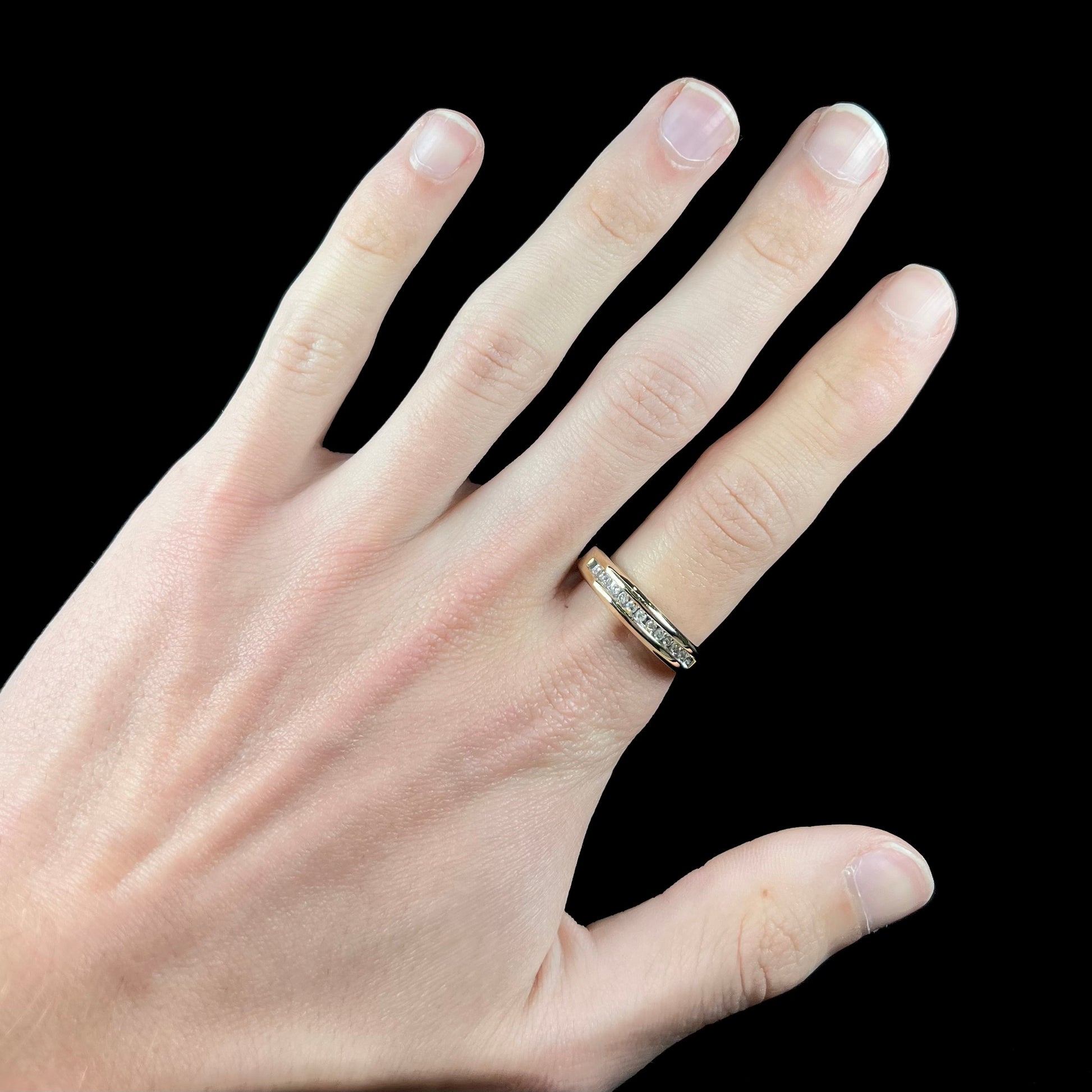 A men's yellow gold channel set diamond wedding band.