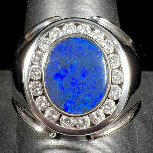 A men's black crystal opal and diamond halo ring in white gold.