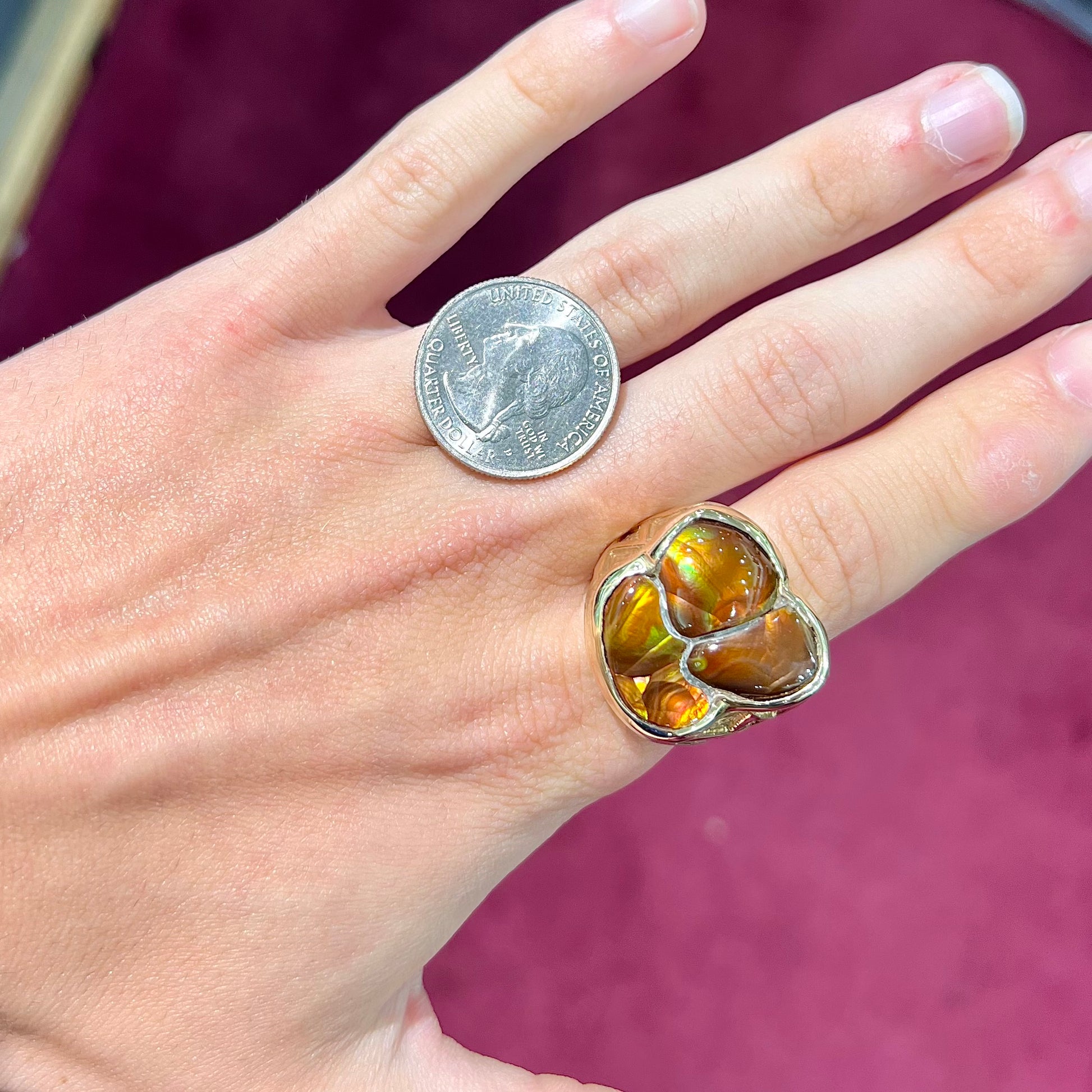 A men's yellow gold ring inlaid with three freeform cut fire agate stones.