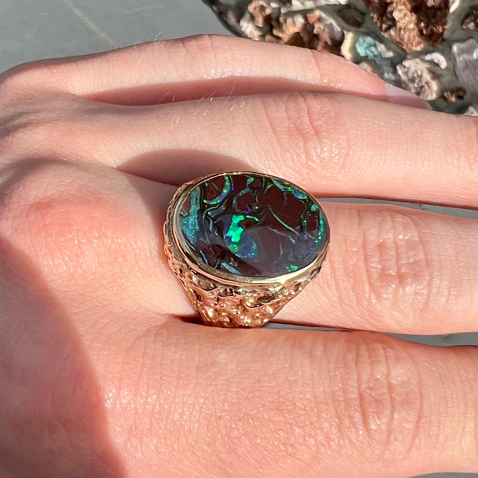 A men's yellow gold nugget style Koroit boulder opal solitaire ring.