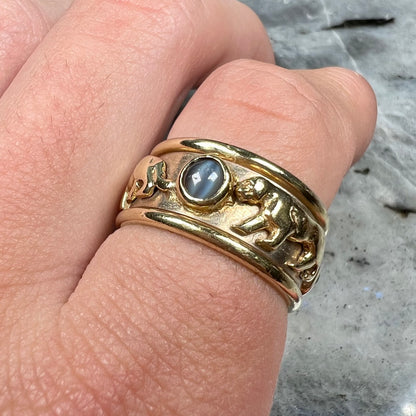 Men's gold ring set with three cabochon cut cat's eye alexandrite stones and panther designs.