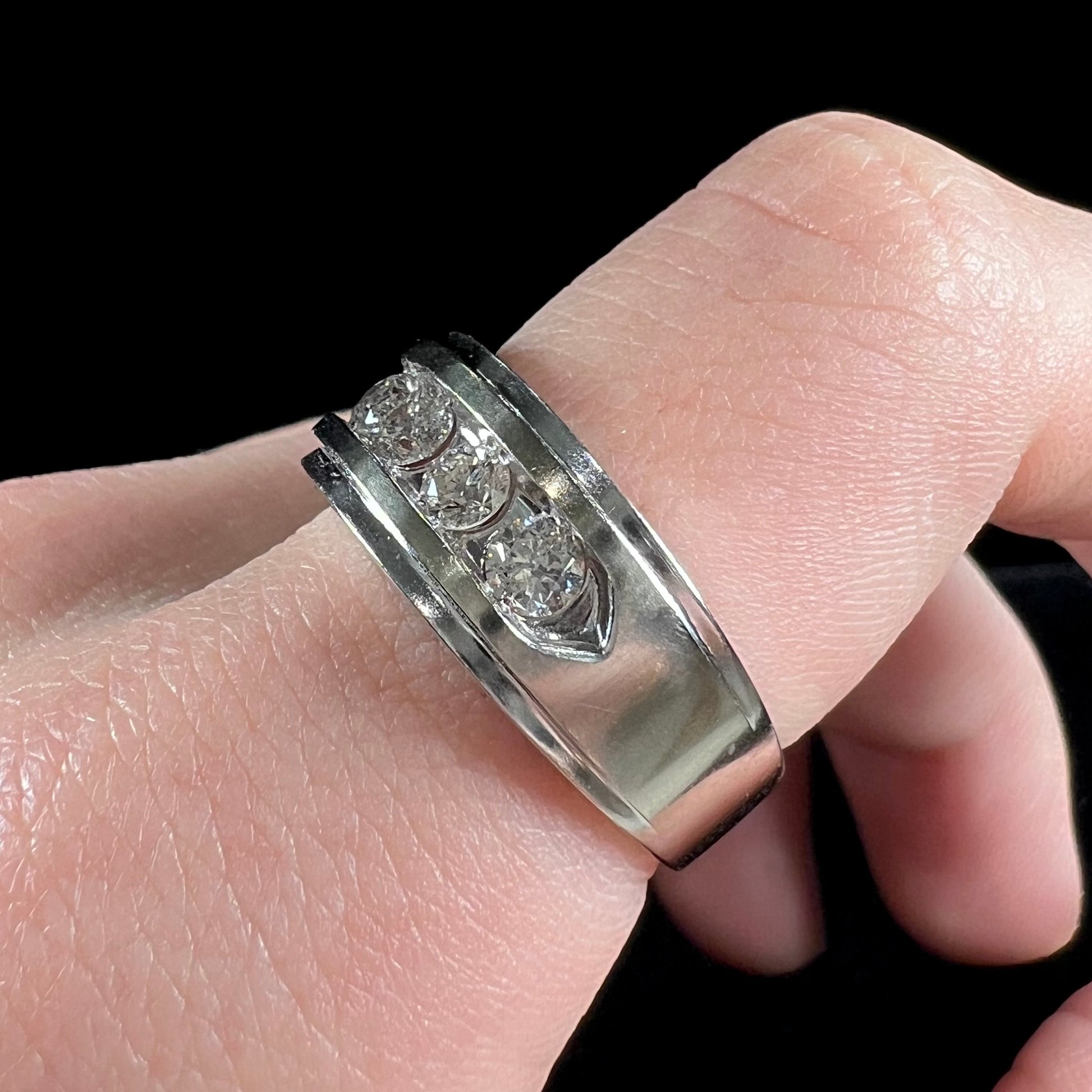 A men's estate white gold five stone diamond ring.
