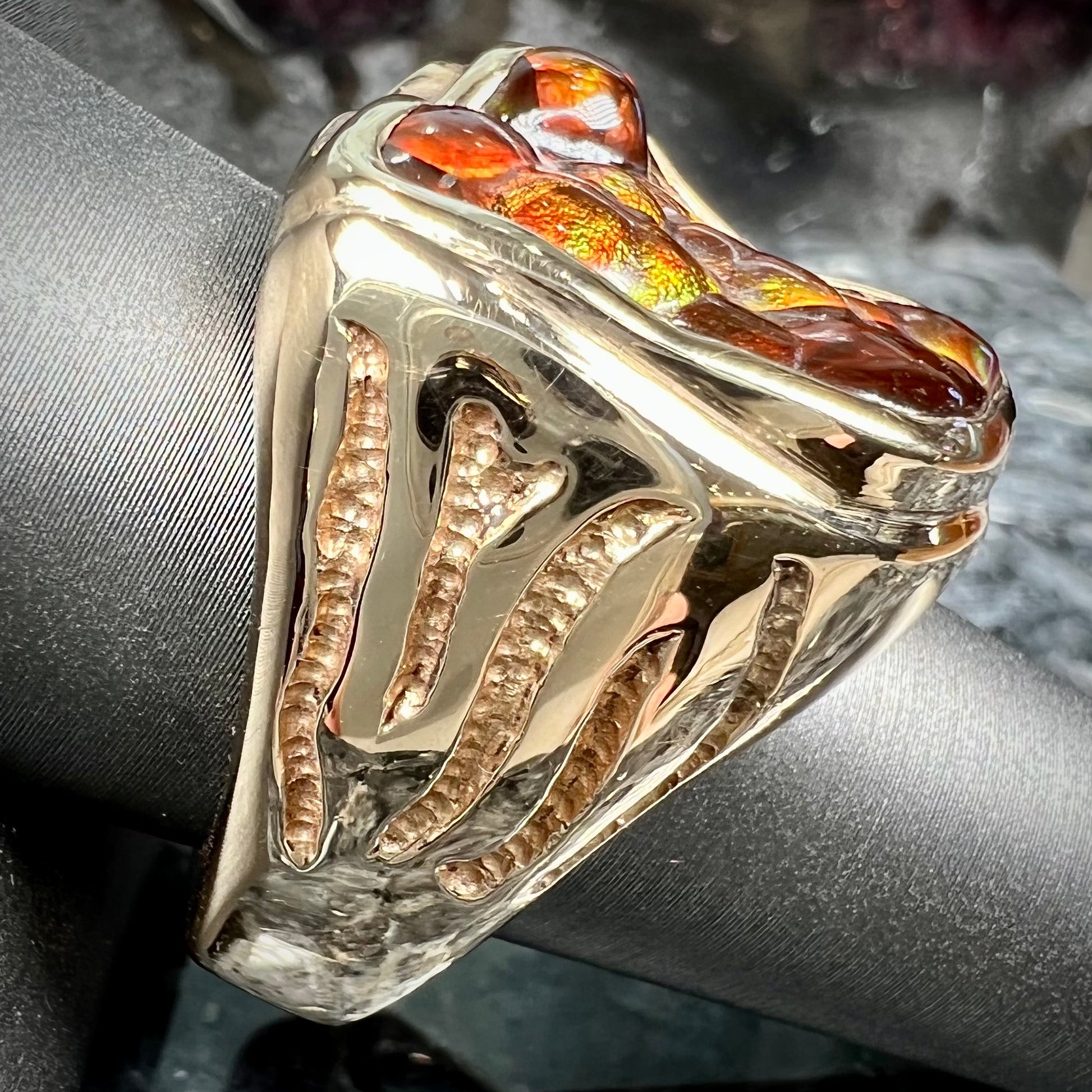 A men's custom fire agate solitaire ring cast in yellow gold.