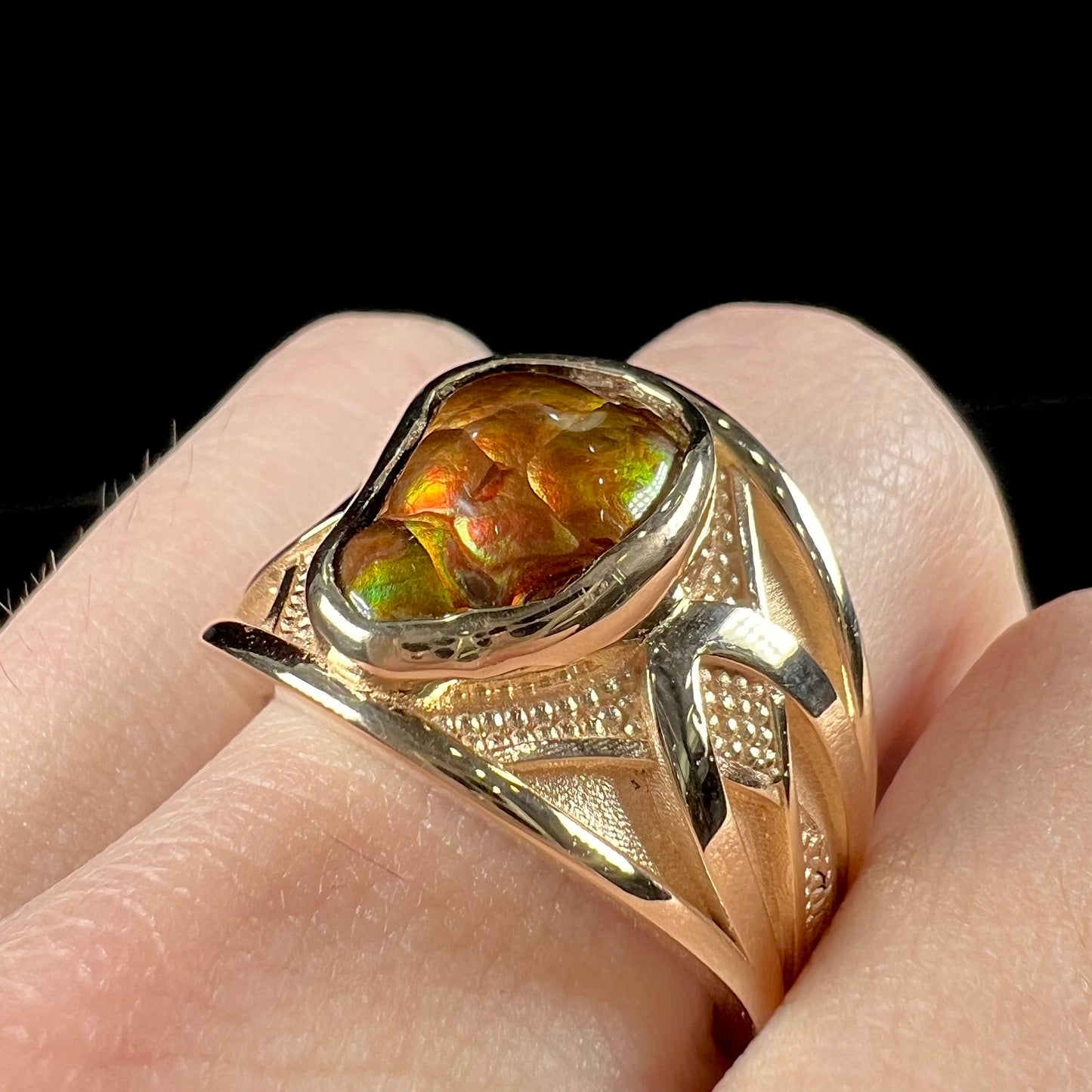 A men's 14kt yellow gold Mexican fire agate ring.