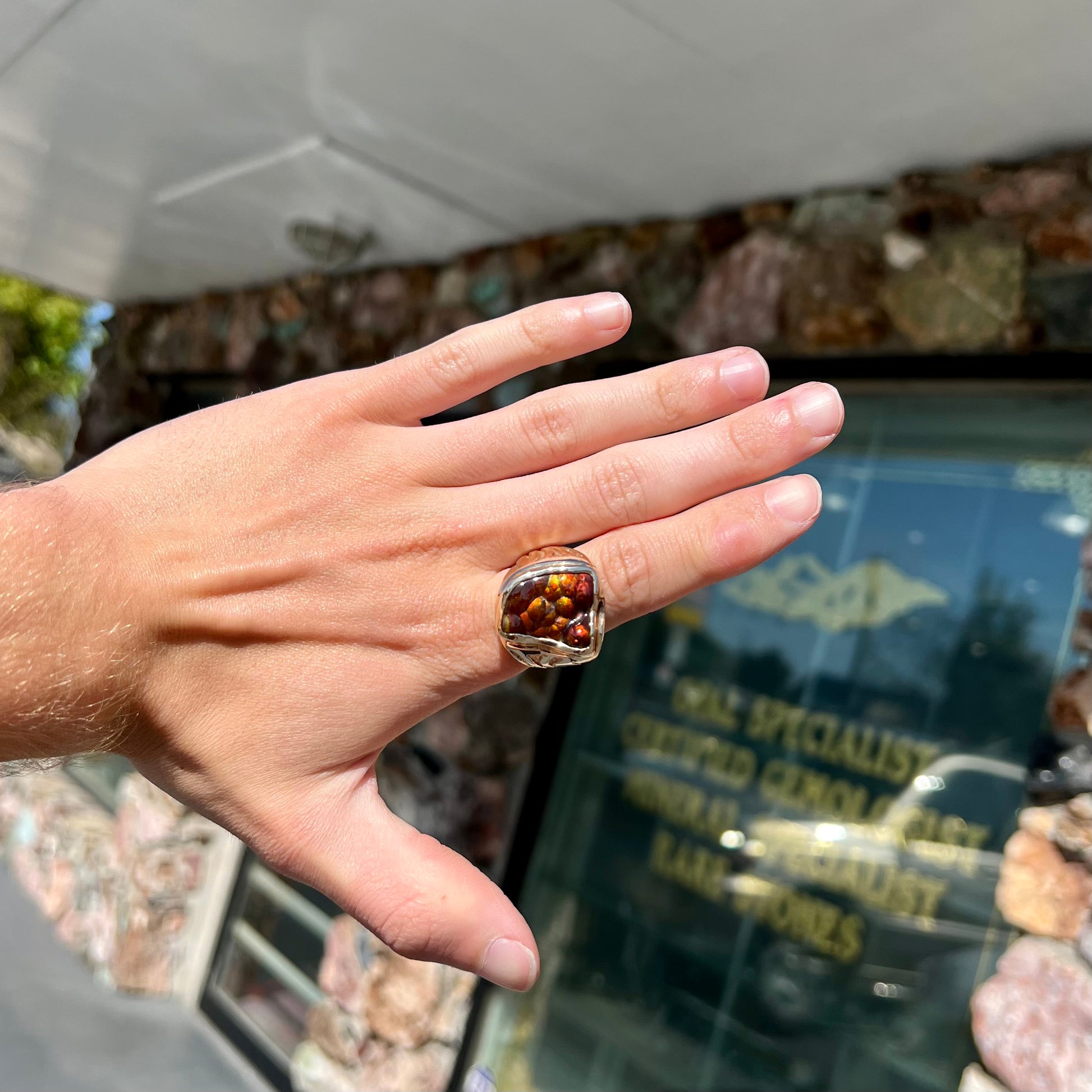 A men's custom fire agate solitaire ring cast in yellow gold.