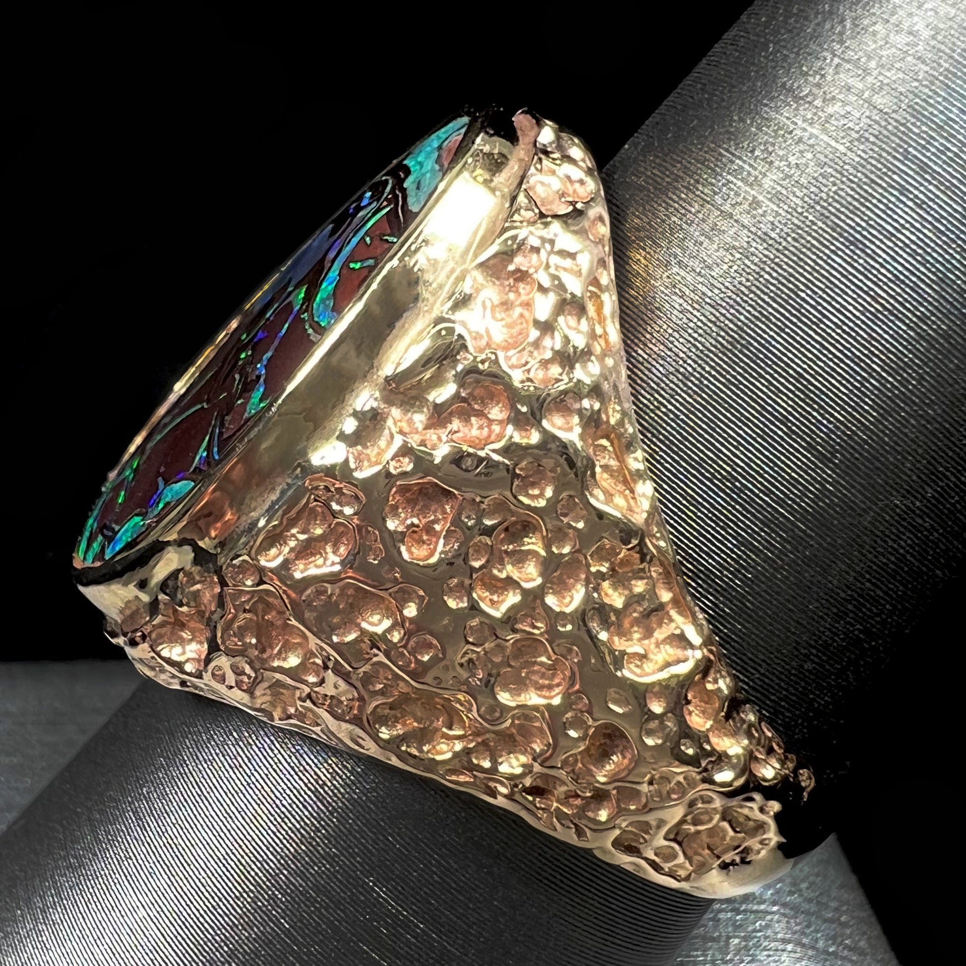 A men's yellow gold nugget style Koroit boulder opal solitaire ring.