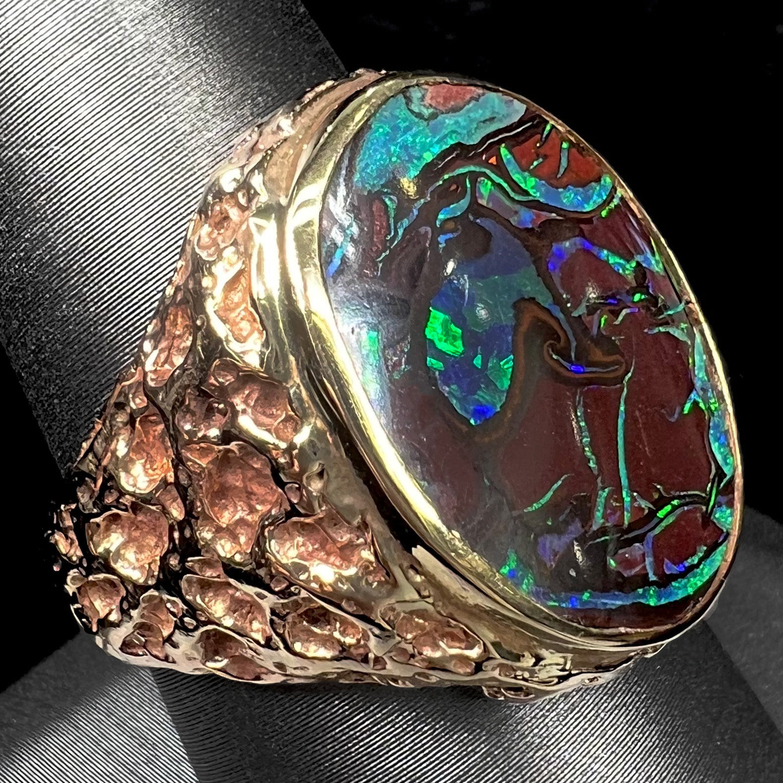 A men's yellow gold nugget style Koroit boulder opal solitaire ring.