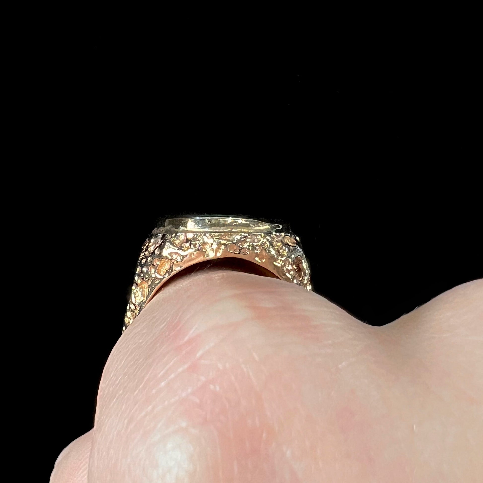 A men's yellow gold nugget style Koroit boulder opal solitaire ring.