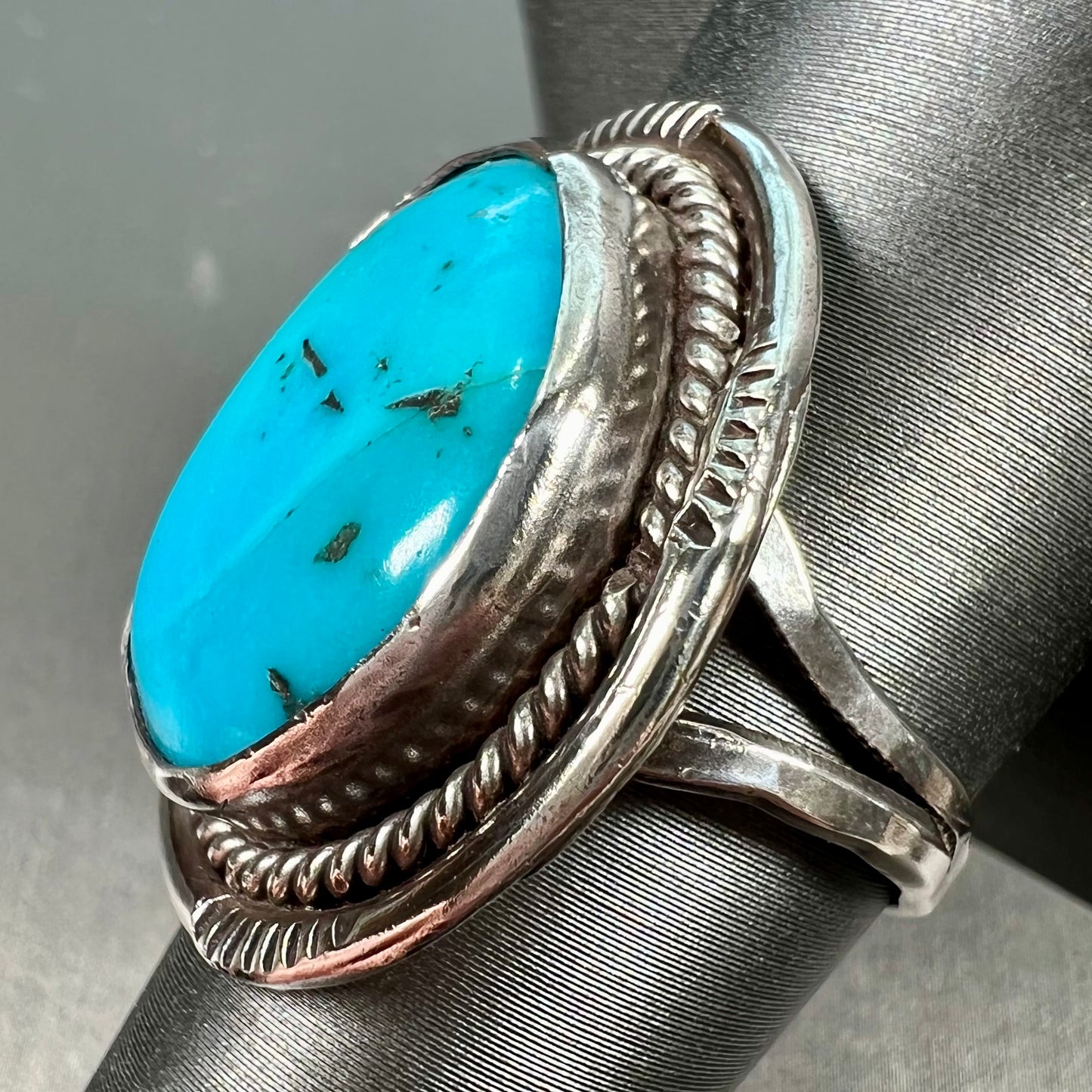 A men's silver, handmade, Navajo turquoise ring.