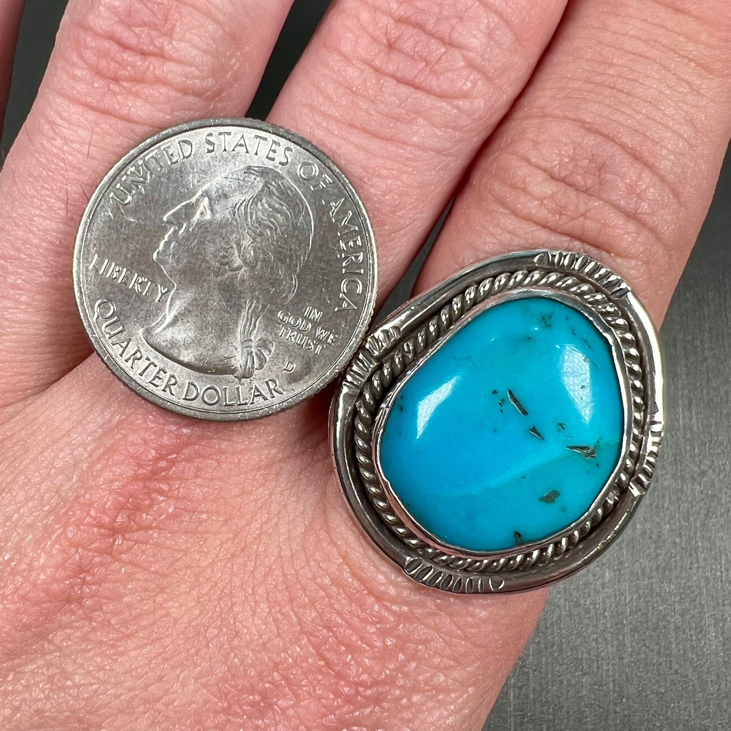 A men's silver, handmade, Navajo turquoise ring.